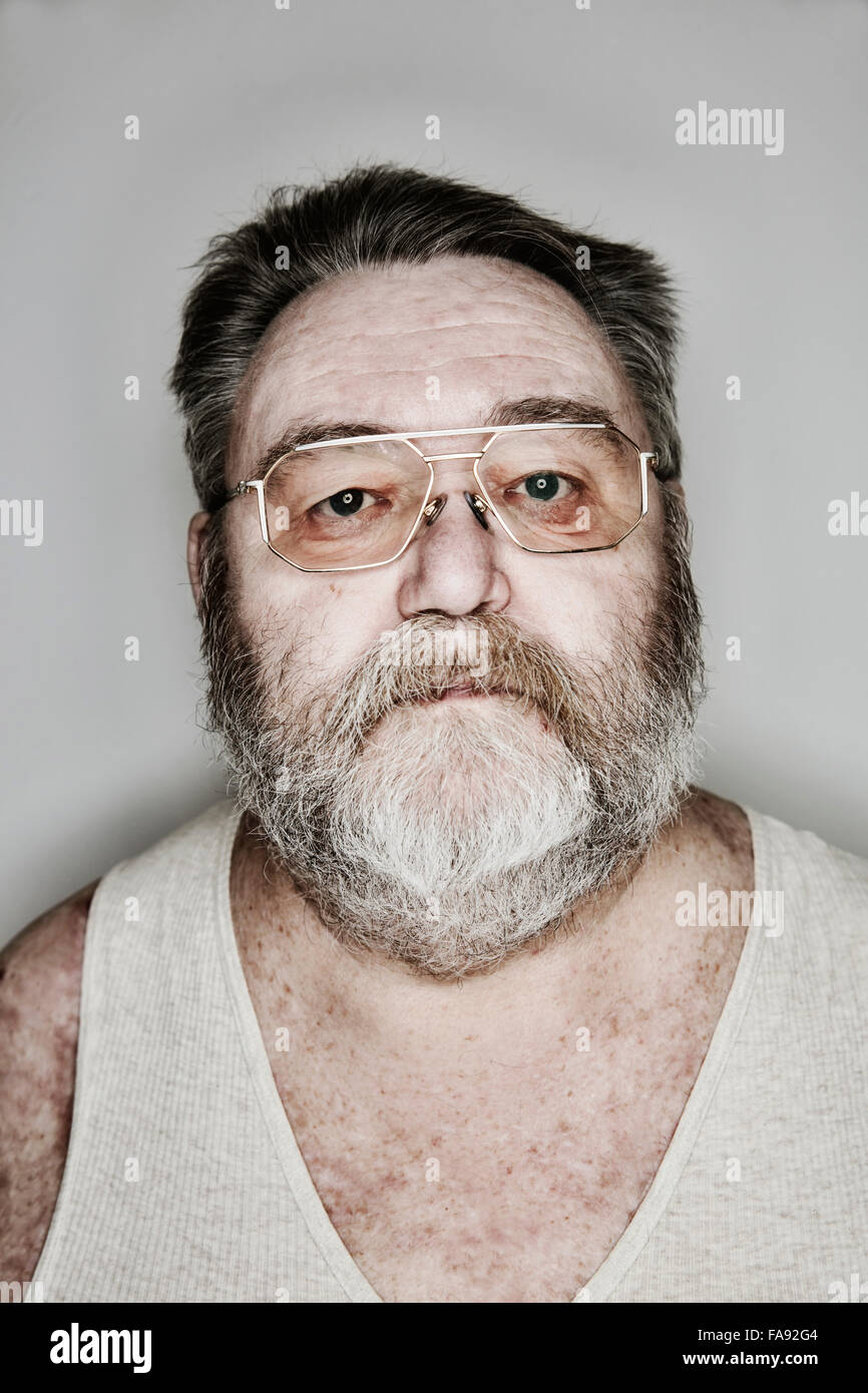 Senior with beard and glasses in his undershirt, portrait, Germany Stock Photo