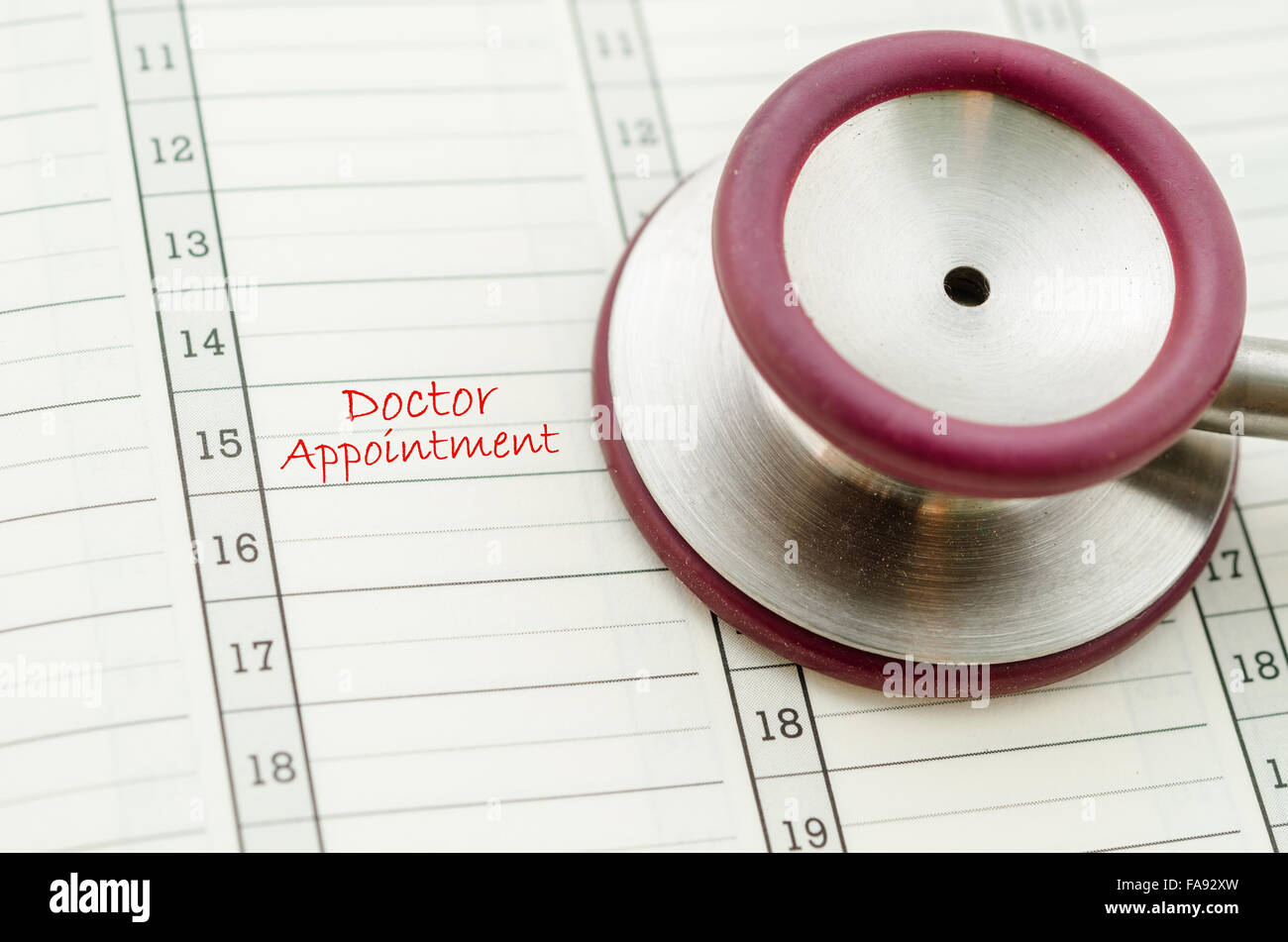A scheduled doctors appointment is wrote on a calendar for a patient with stethoscope. Stock Photo