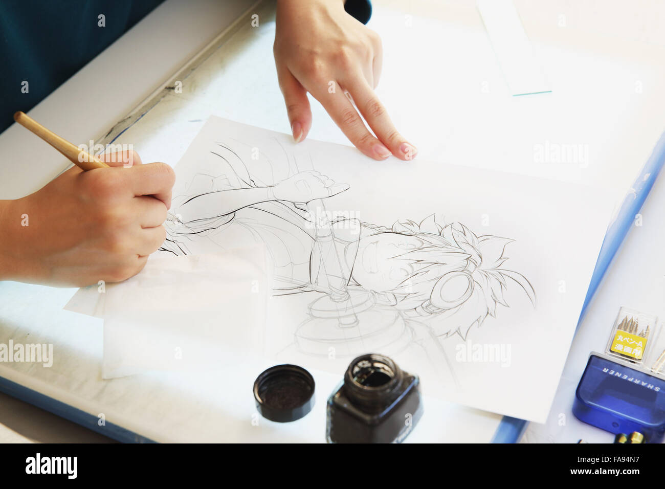 Japanese Manga artist working in the studio Stock Photo - Alamy