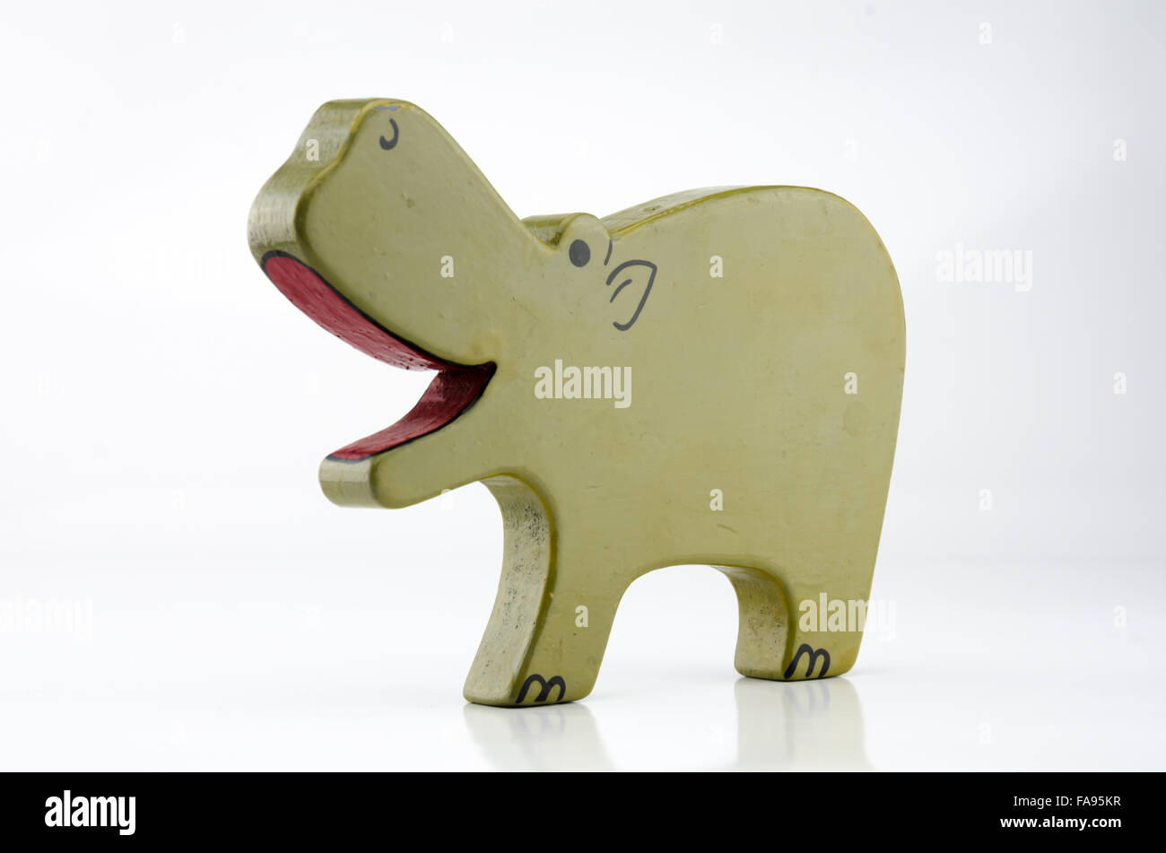 A painted wooden hippo toy on a white backgroud with a three quarter view Stock Photo
