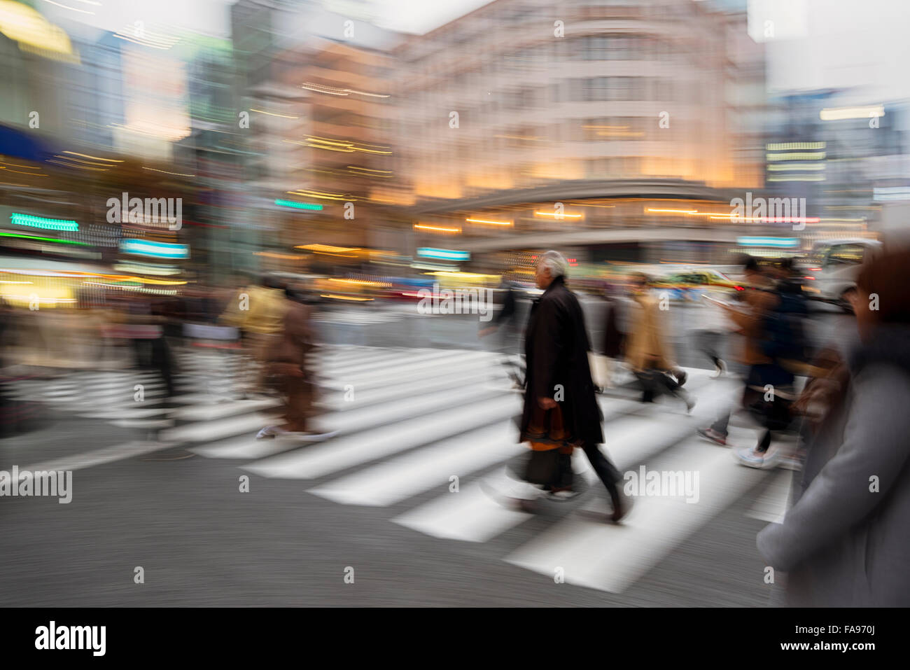 People rushing at heart of the Ginza shopping district in Tokyo. The iconic  Ginza Wako building is at the backround. Stock Photo