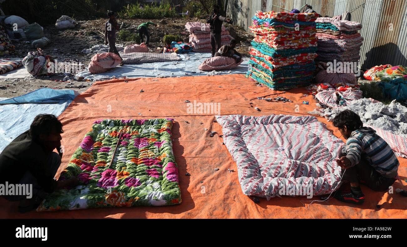 Kathmandu, Nepal. 23rd Dec, 2015. Workers prepare cotton quilts and beddings in Kathmandu, Nepal, Dec. 23, 2015. As winter approaching, such local products are highly demanded because they are warmer than other imported products. © Sunil Sharma/Xinhua/Alamy Live News Stock Photo