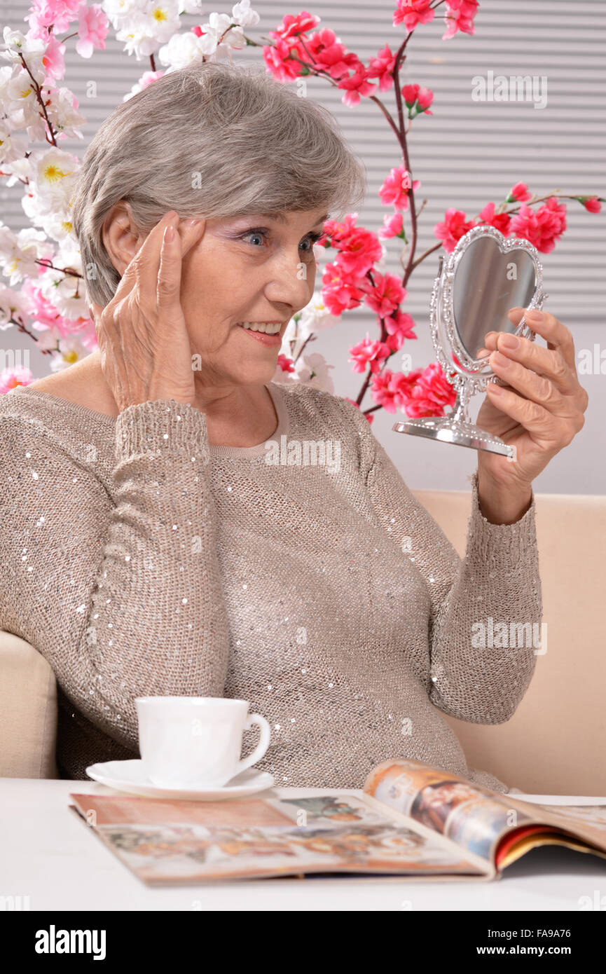 Elderly woman with mirror Stock Photo