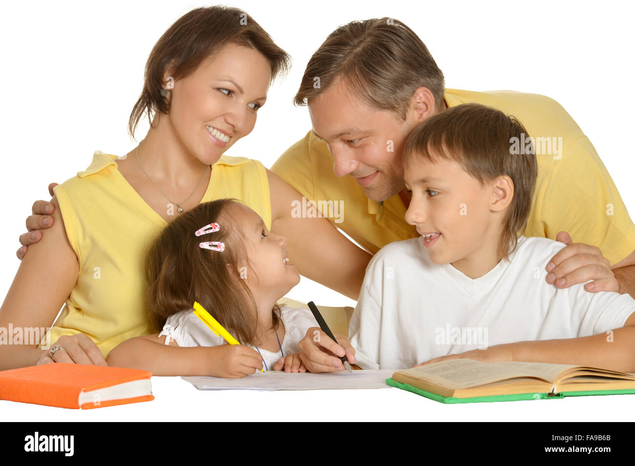 Parents help children with homework Stock Photo - Alamy