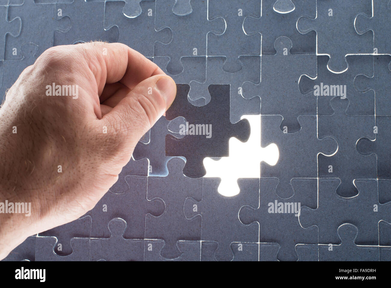 Missing jigsaw puzzle piece with light glow Stock Photo Alamy