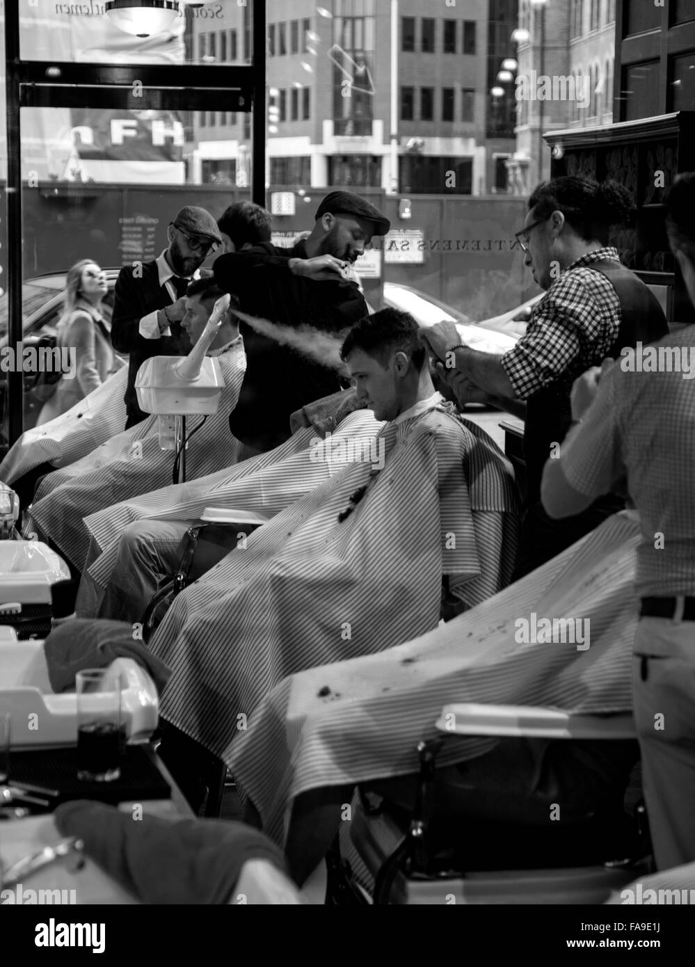 Black and white photo of busy men's barber shop Stock Photo