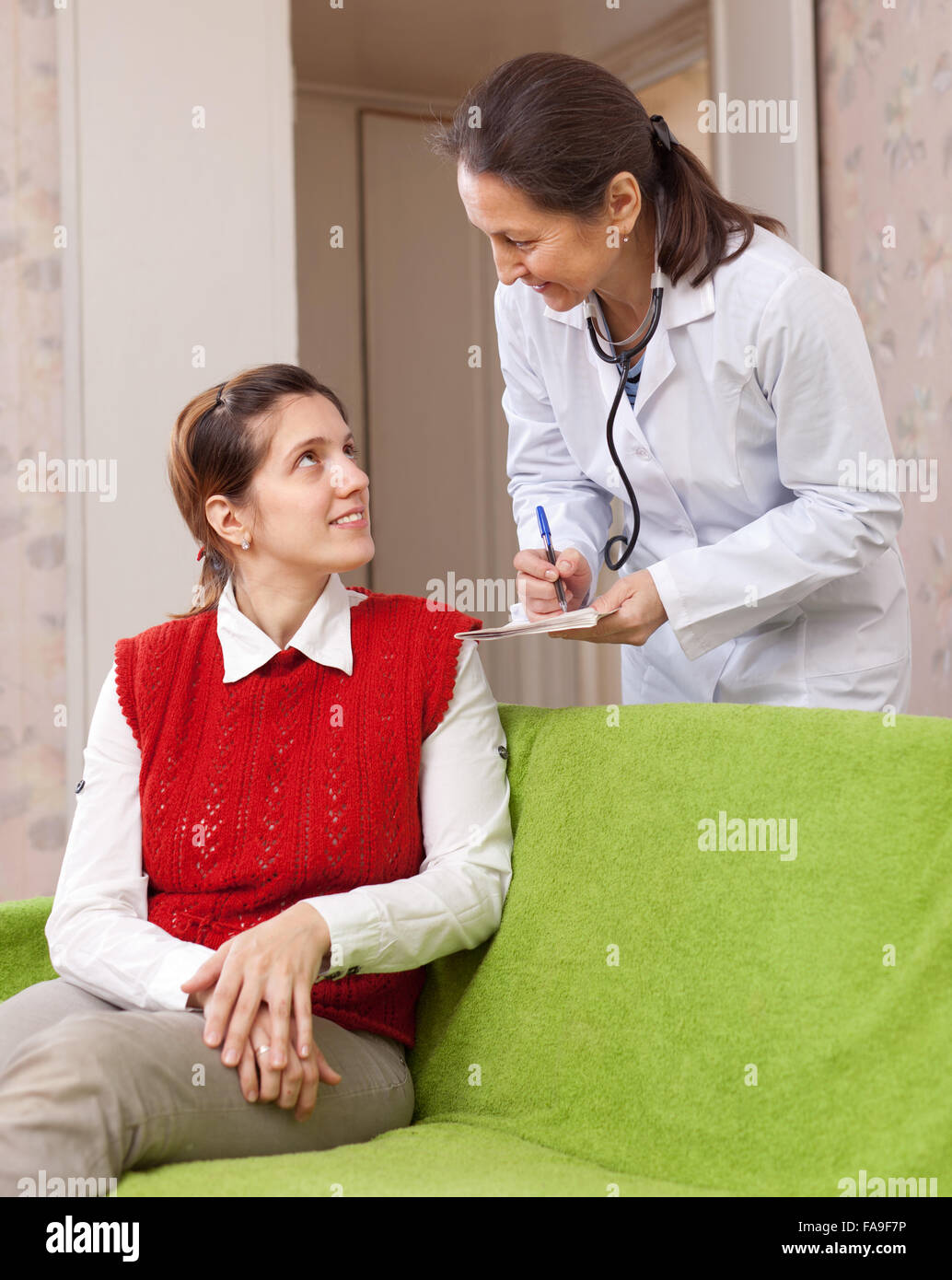 Doctor of prescribes to patient the medication at hospital Stock Photo