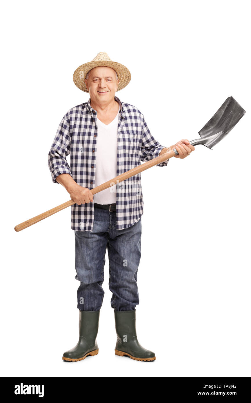 Full length portrait of a mature agricultural worker holding a shovel ...