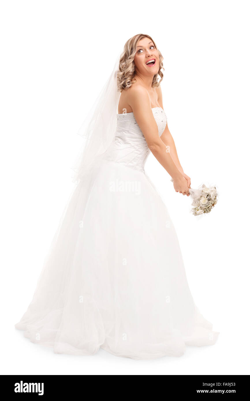 Full length portrait of a young blond bride tossing her wedding bouquet isolated on white background Stock Photo