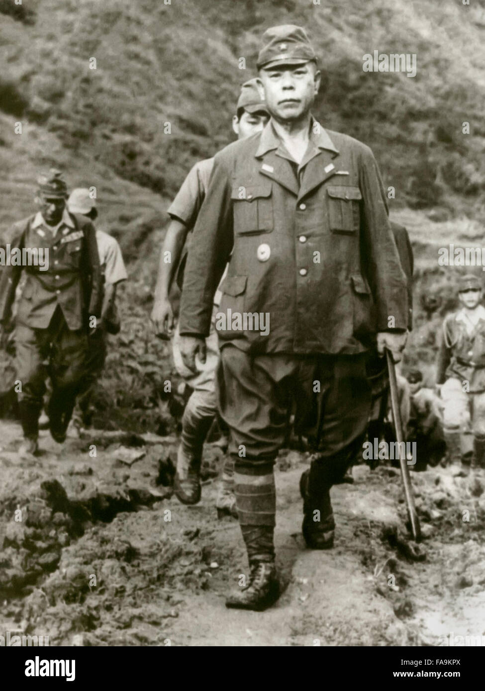 Tomoyuki Yamashita (1885-1946), Imperial Japanese Army general and his staff walk down the trail to U.S. forces in northern Luzon. From 29 October to 7 December 1945, an American military tribunal in Manila tried General Yamashita for war crimes relating to the Manila massacre and many atrocities in the Philippines and Singapore. The court found Yamashita guilty as charged and sentenced him to death. Photograph taken September 1945 following his surrender. Stock Photo