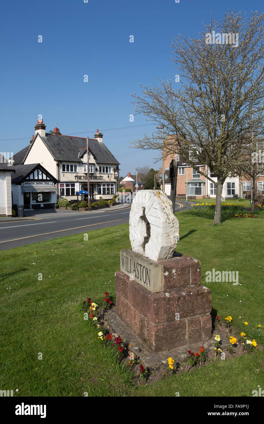 Village of Willaston, Cheshire, England. Picturesque view of Willaston’s  millstone and village sign. Stock Photo