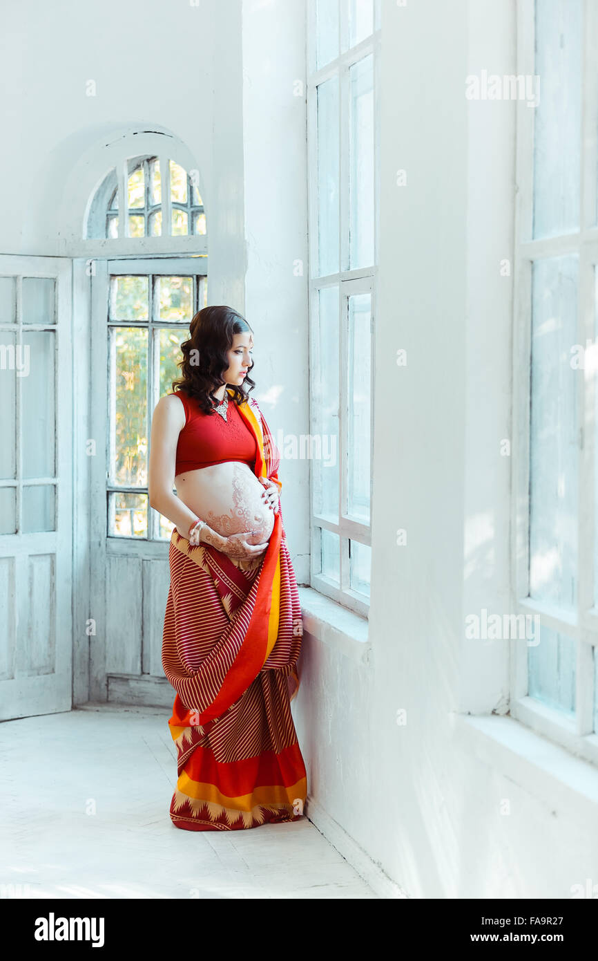 The pregnant woman belly with henna tattoo Stock Photo - Alamy