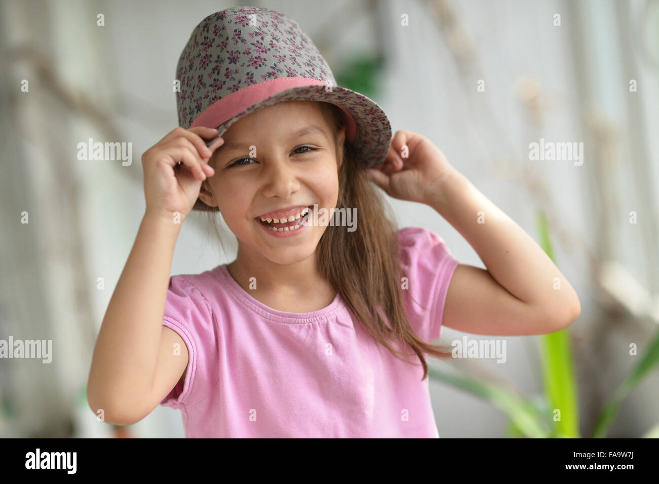 Little girl in hat posing Stock Photo Alamy