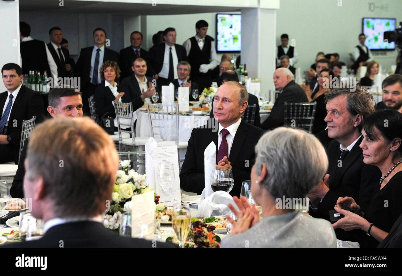 Russian President Vladimir Putin sits with Serbian filmmaker Emir Kusturica, left, during a reception marking the 10th anniversary of television network Russia Today December 10, 2015 in Moscow, Russia. Stock Photo