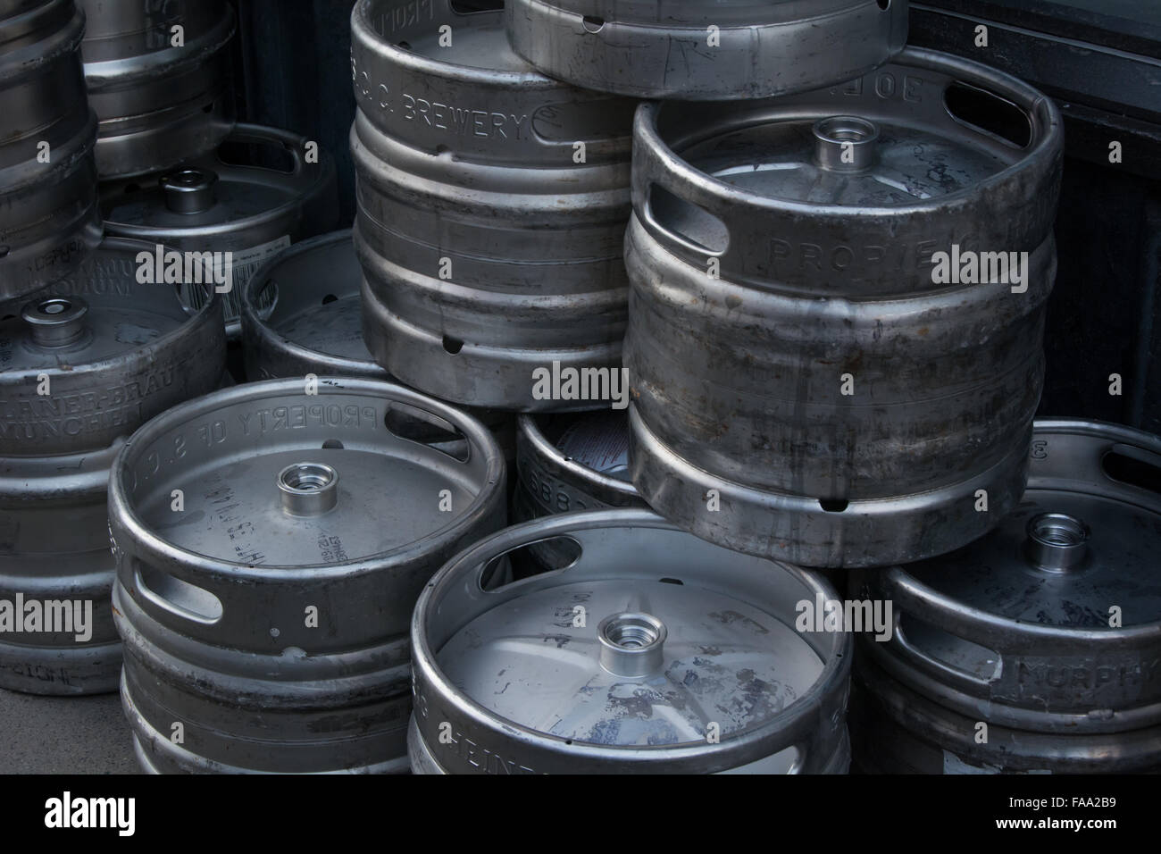 Different types of metal beer kegs being distributed and stored in