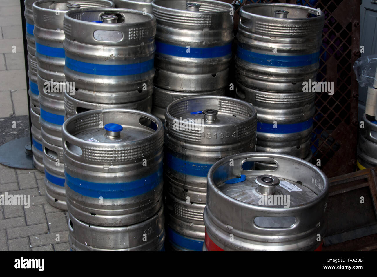 Different types of metal beer kegs being distributed and stored in