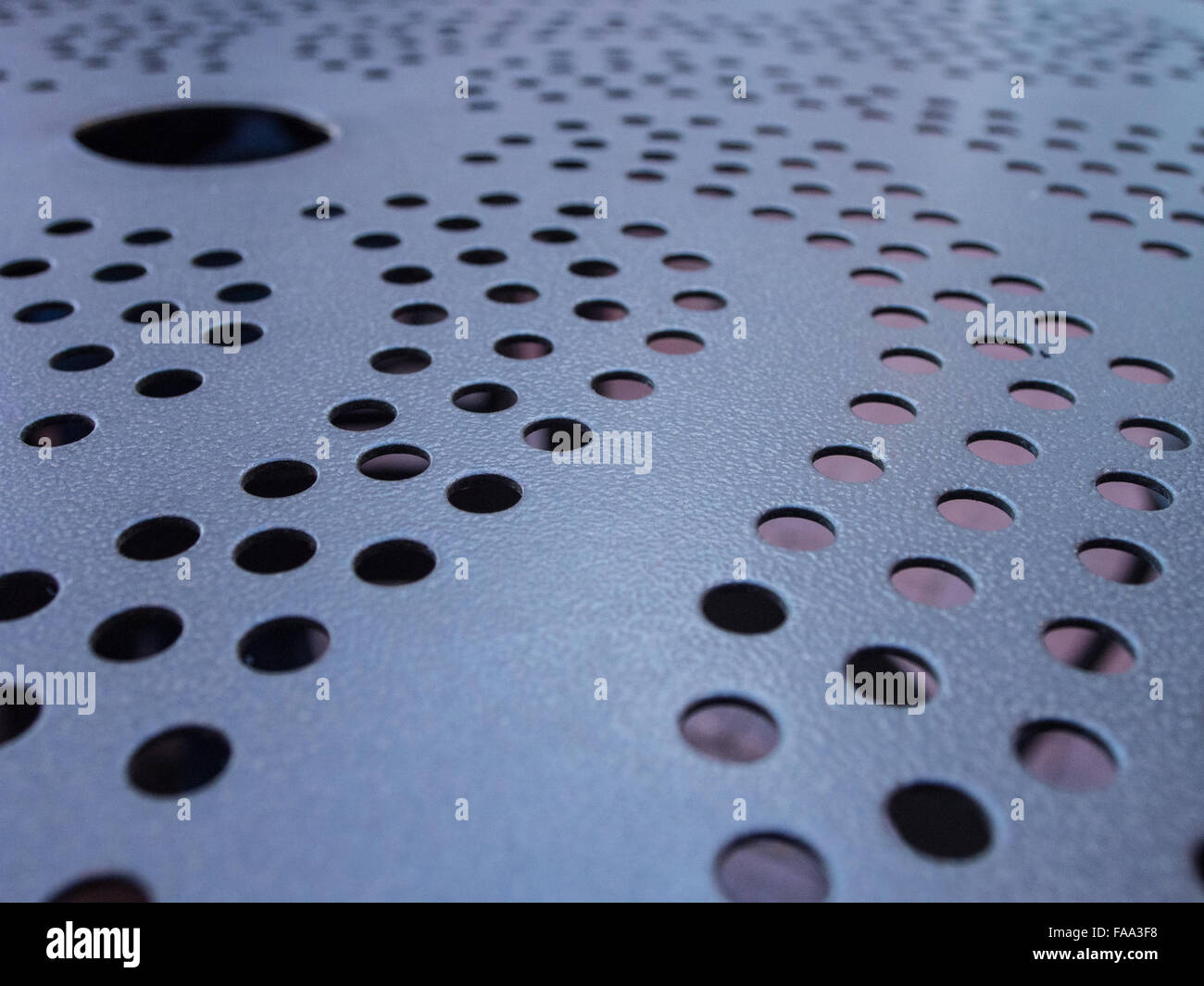 Metal table with holes and swirls design Stock Photo