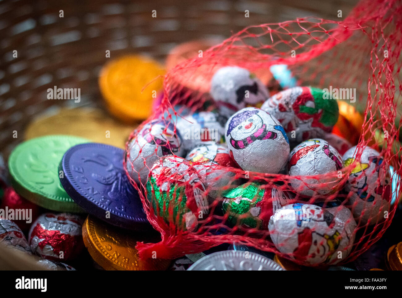 Assorted Christmas chocolates in a net bag amongst some colourful