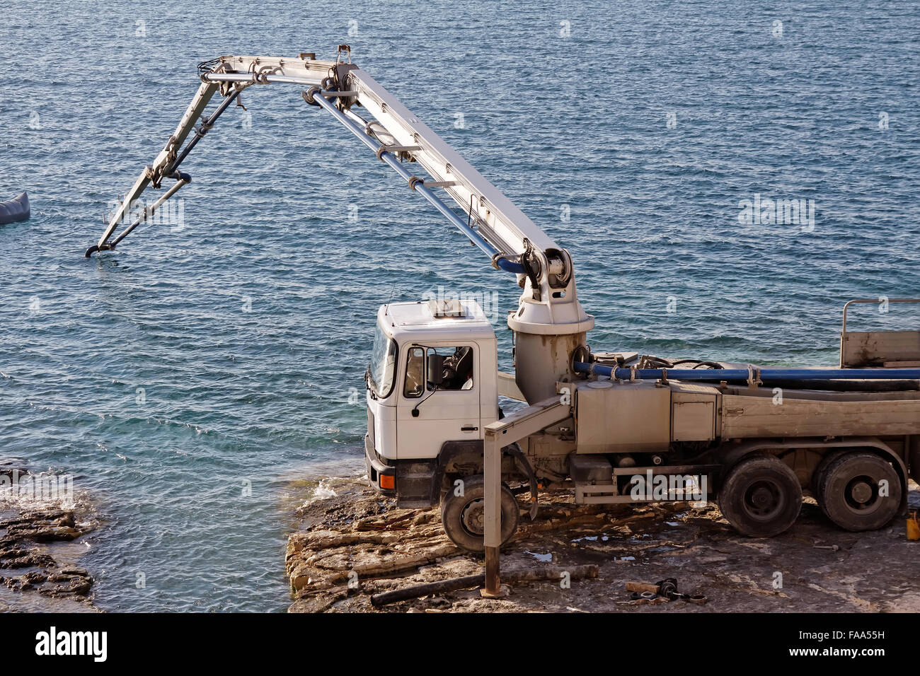 concrete pumping line on construction site under the sea Stock Photo