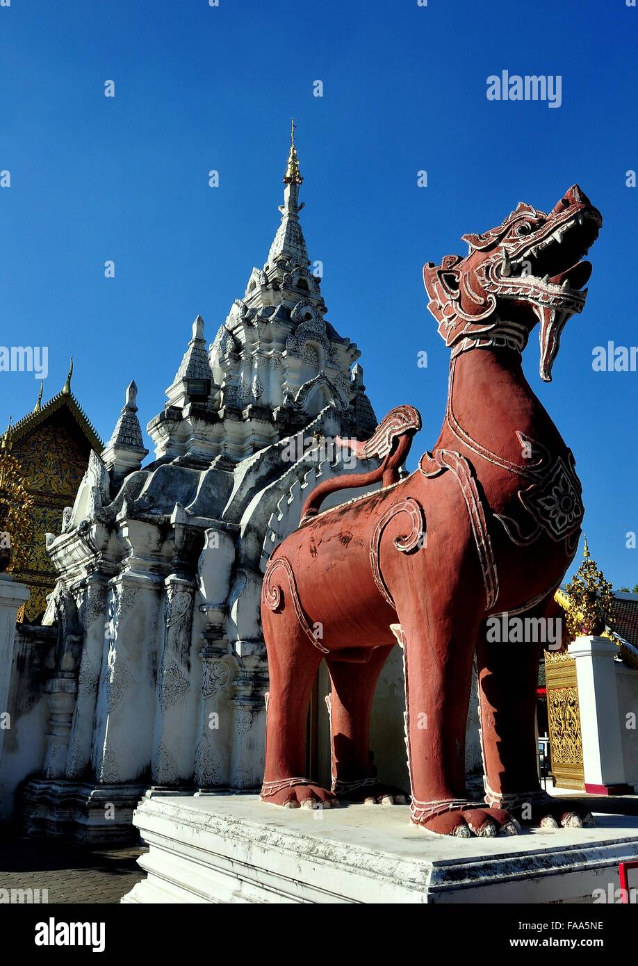 Lamphun, Thailand:  Terra cotta mythical beast stands guard at the entrance gate to Wat Phra That Haripunchi Maha Viham Stock Photo