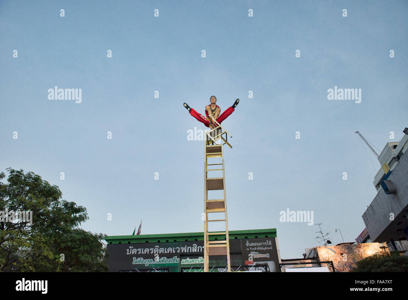 Aerial balancing act at a street festival in Bangkok, Thailand Stock Photo