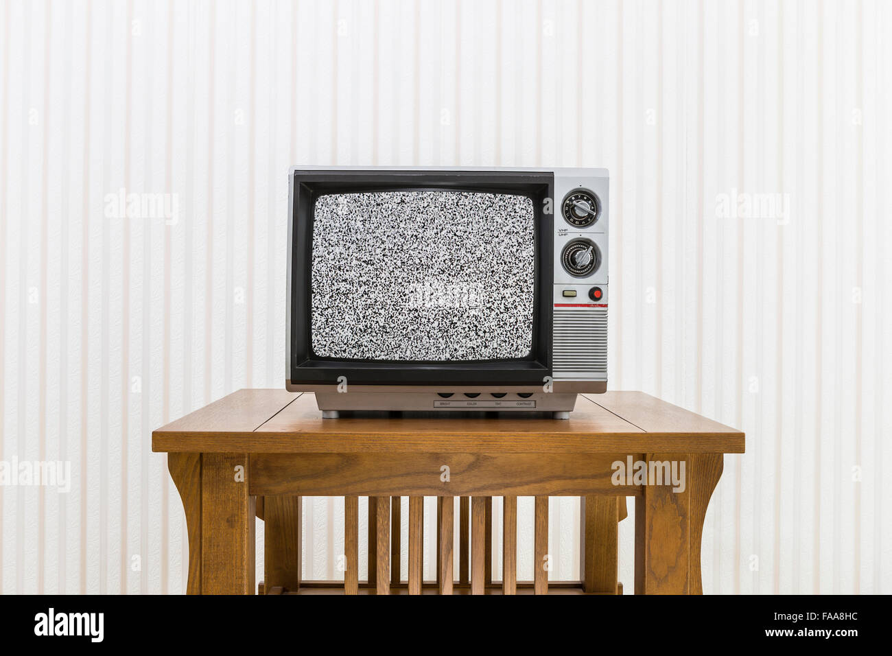 Old portable television on wood table with static screen Stock Photo