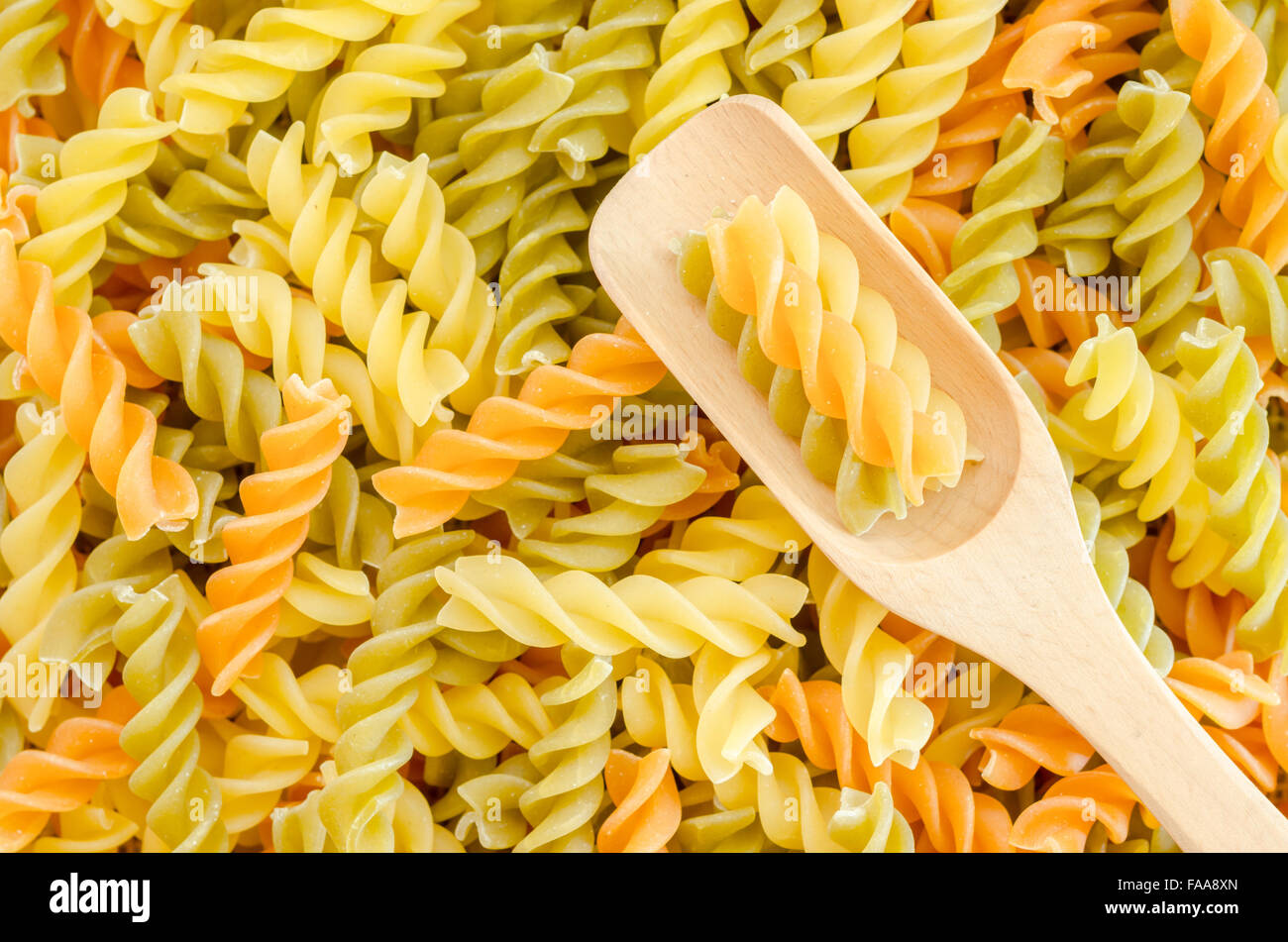 Three Colors Rotini Pasta with wooden spoon Stock Photo Alamy