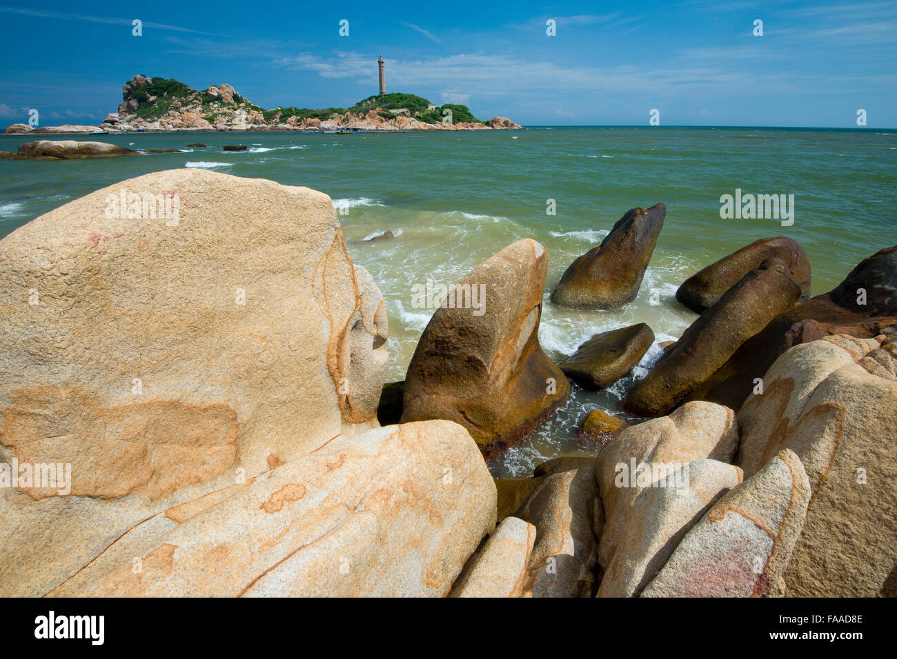 Sandstones in the surf, in the back highest Lighthouse of Vietnam, Phan Thiet, Ke Ga, Vietnam Stock Photo