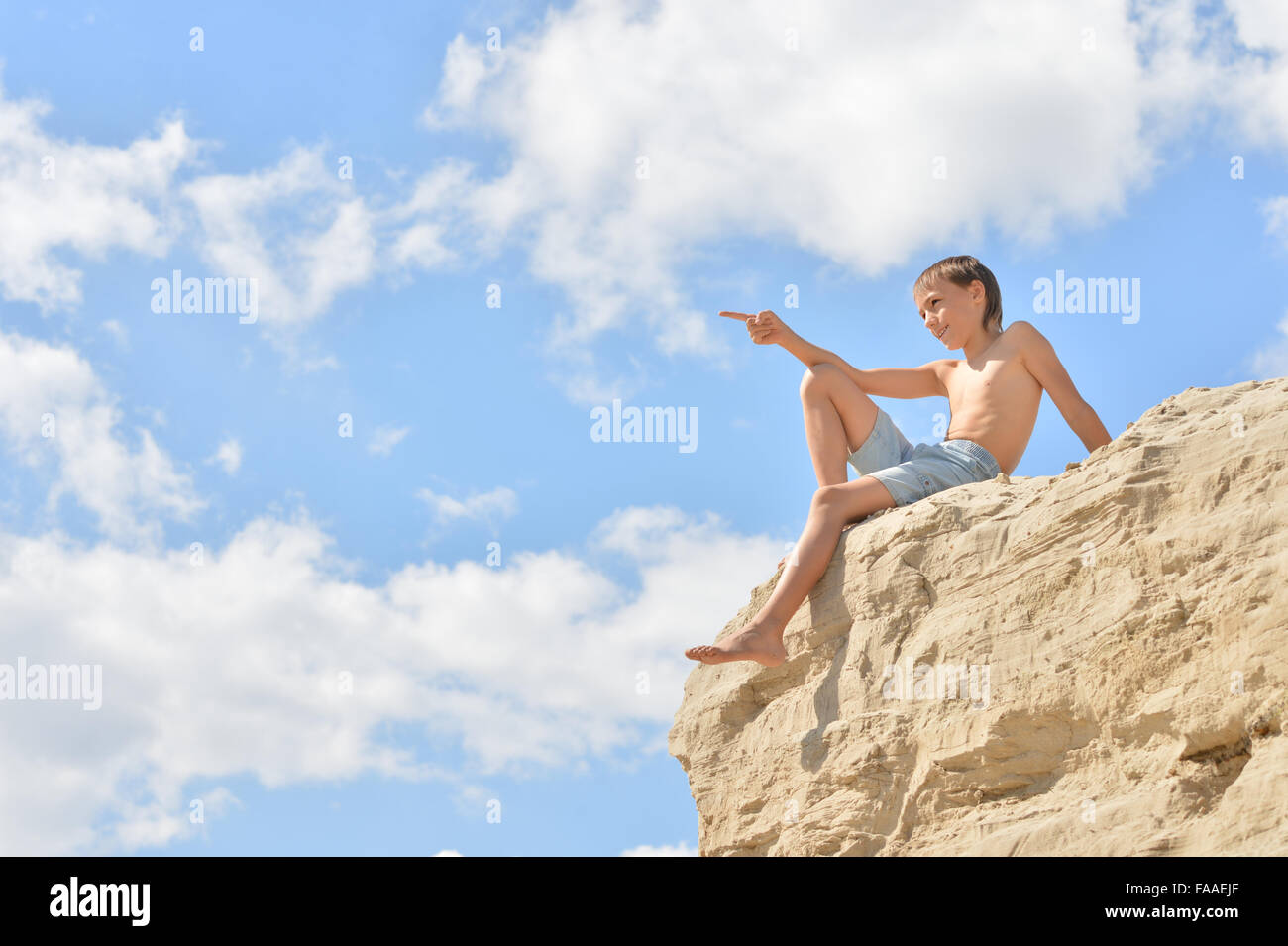 Boy sitting on a hill Stock Photo - Alamy