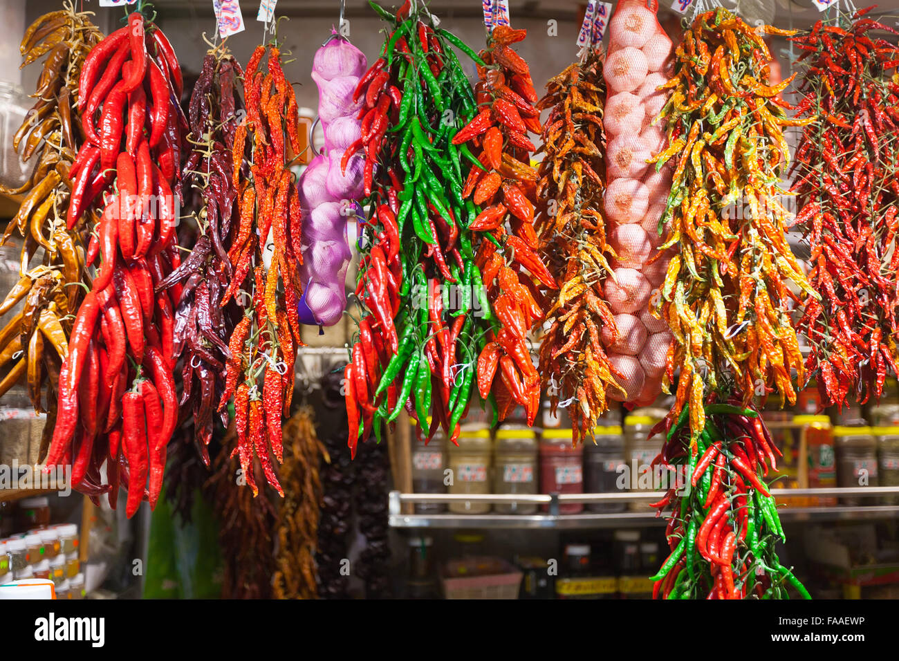 Bundles of red pepper and garlic hanging in spanish market Stock Photo ...