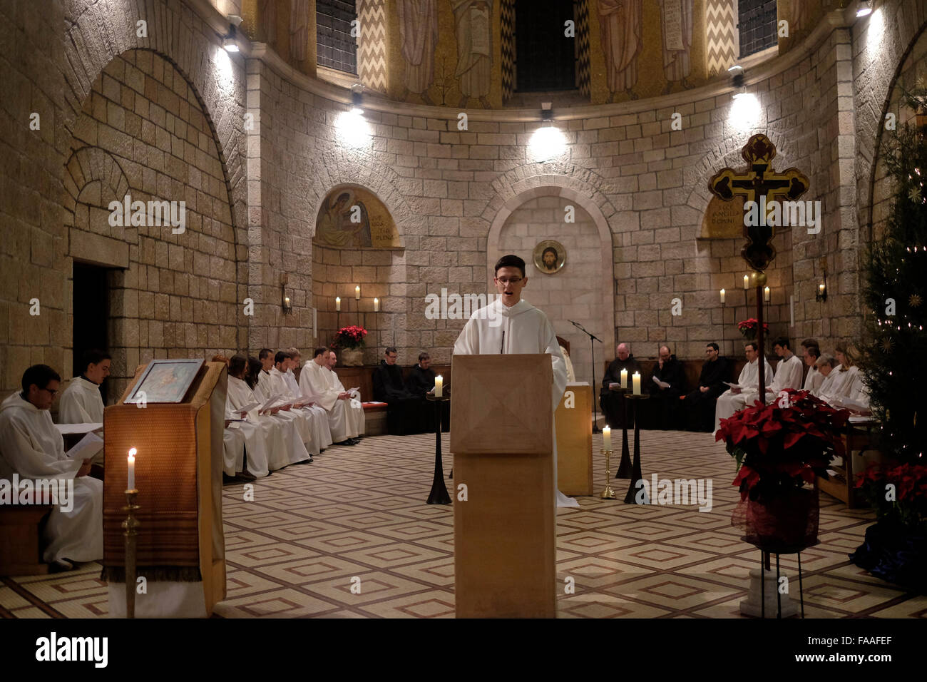 Catholic monks take part in midnight Christmas mass inside the church at the Abbey of the