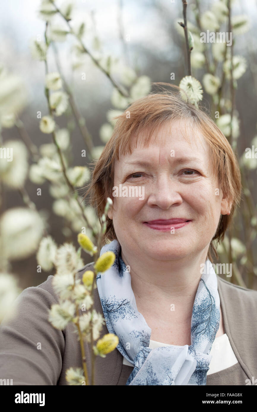 portrait of mature woman in spring pussywillow plant Stock Photo - Alamy
