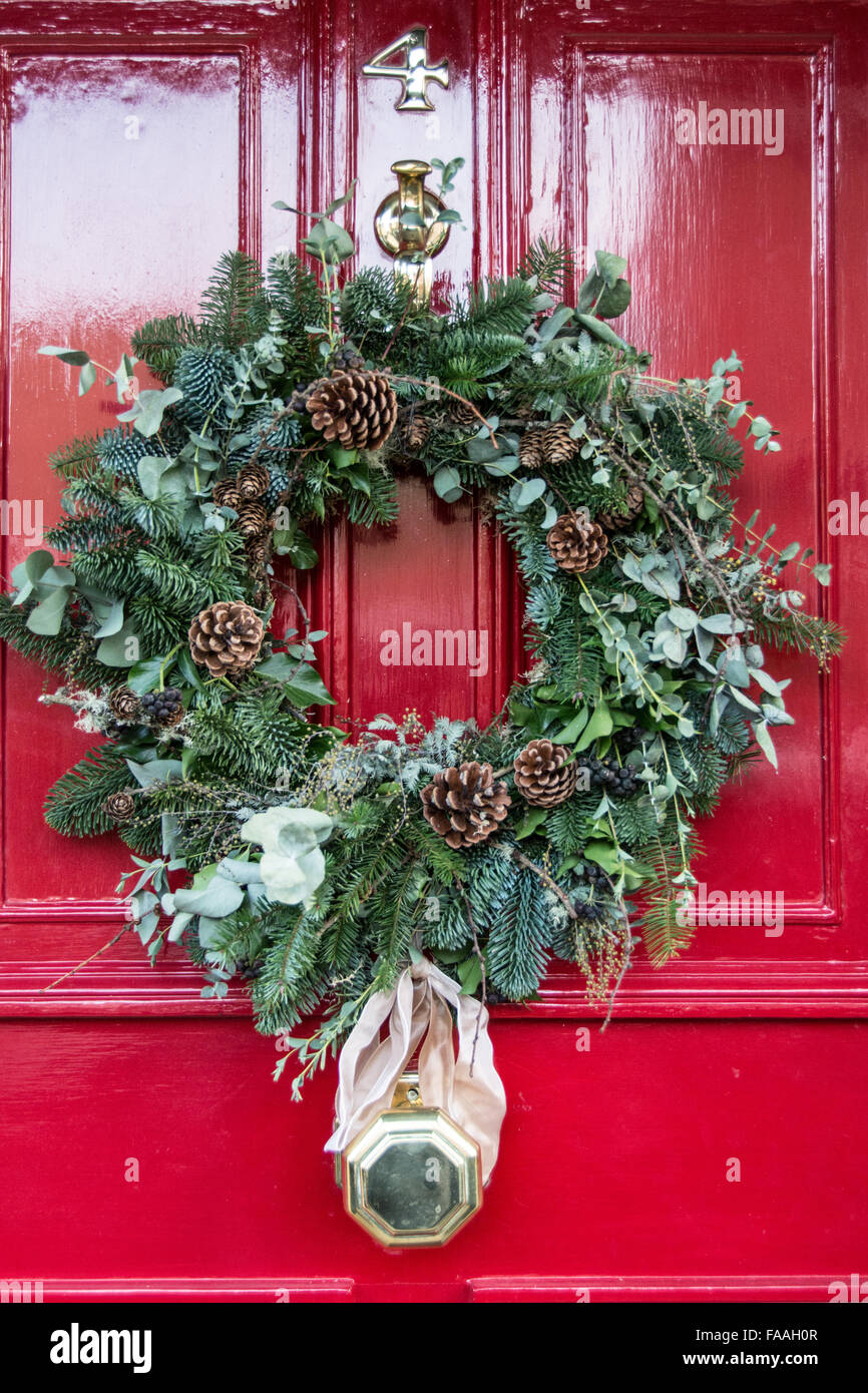 A colourful festive Christmas wreath on a red front door Stock Photo ...