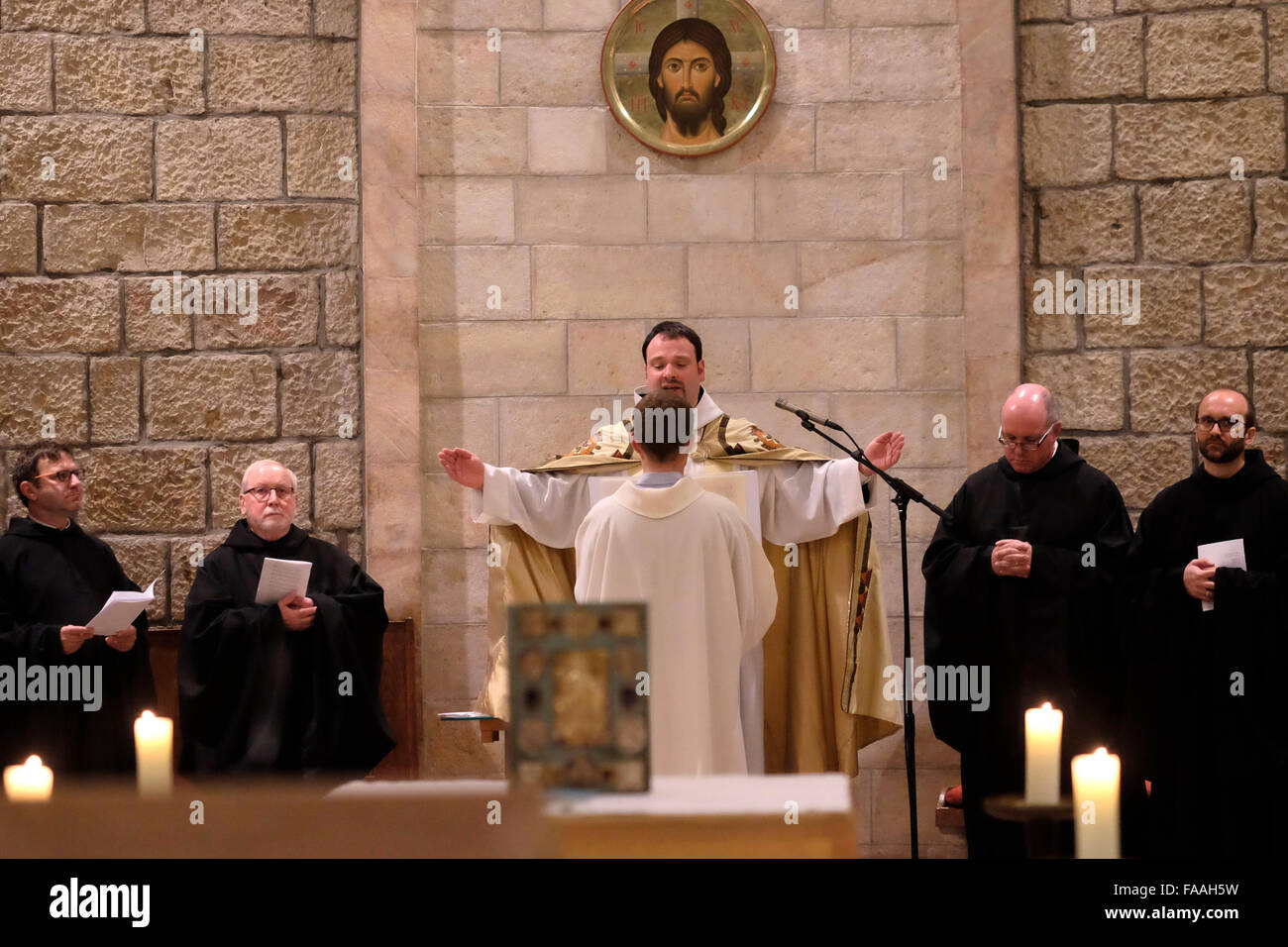 Catholic monks take part in midnight Christmas mass inside the church at the Abbey of the