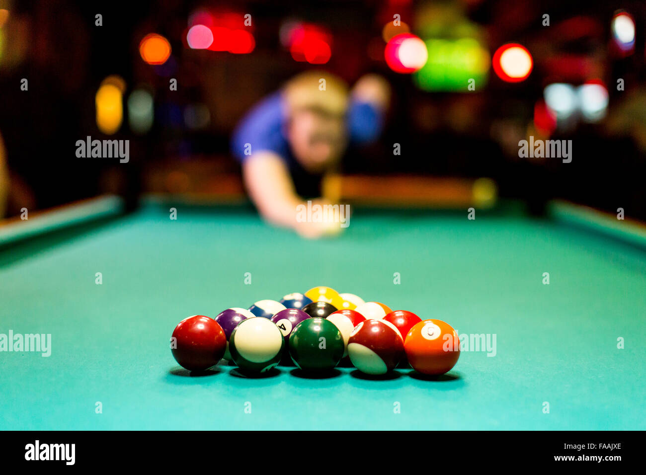 Young man playing snooker in the bar Stock Photo