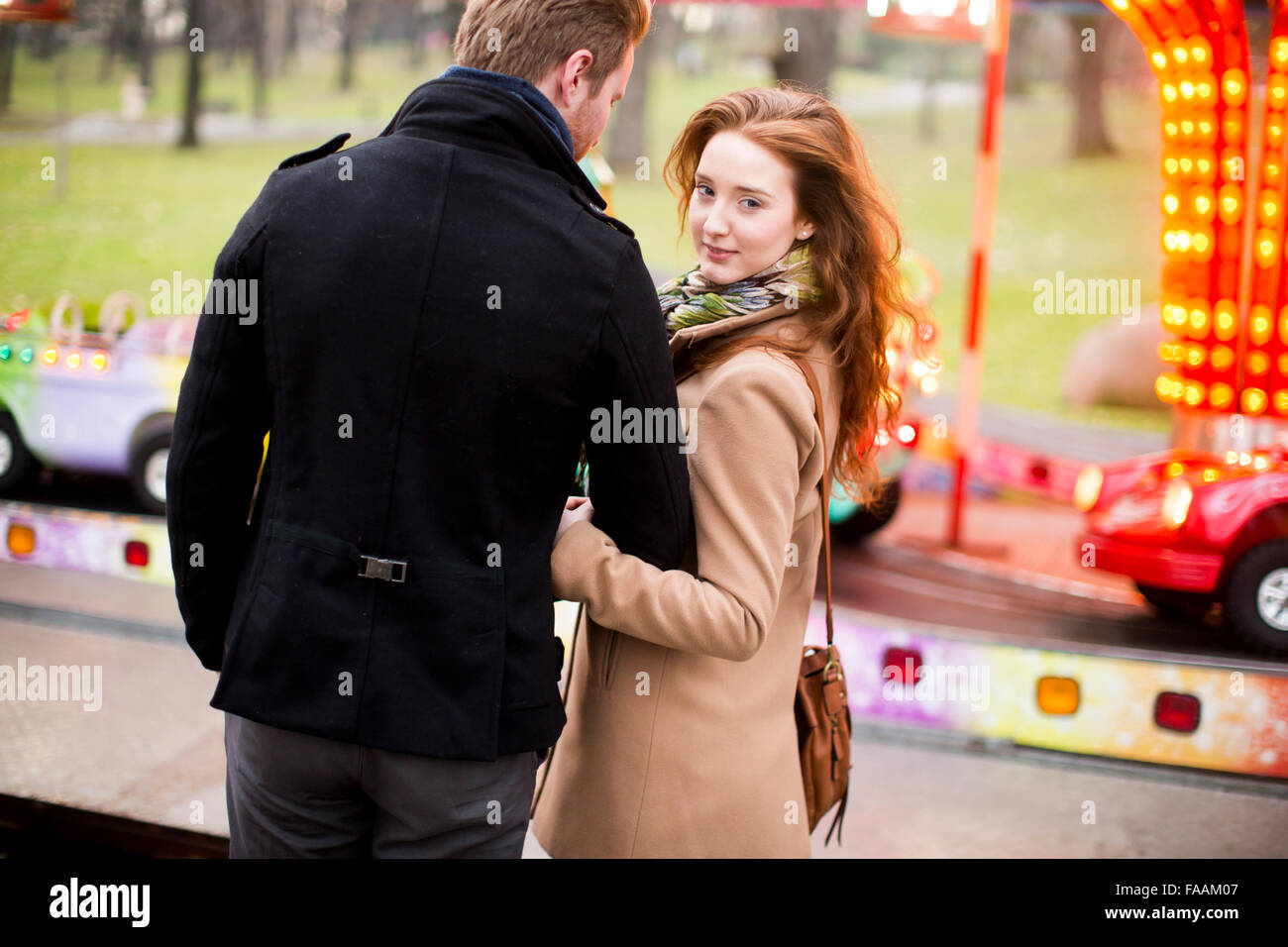 Young couple in the amusement park Stock Photo - Alamy