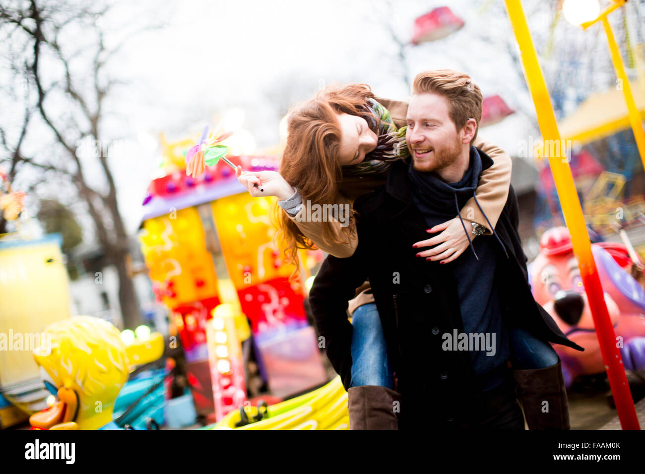 Young couple in the amusement park Stock Photo - Alamy