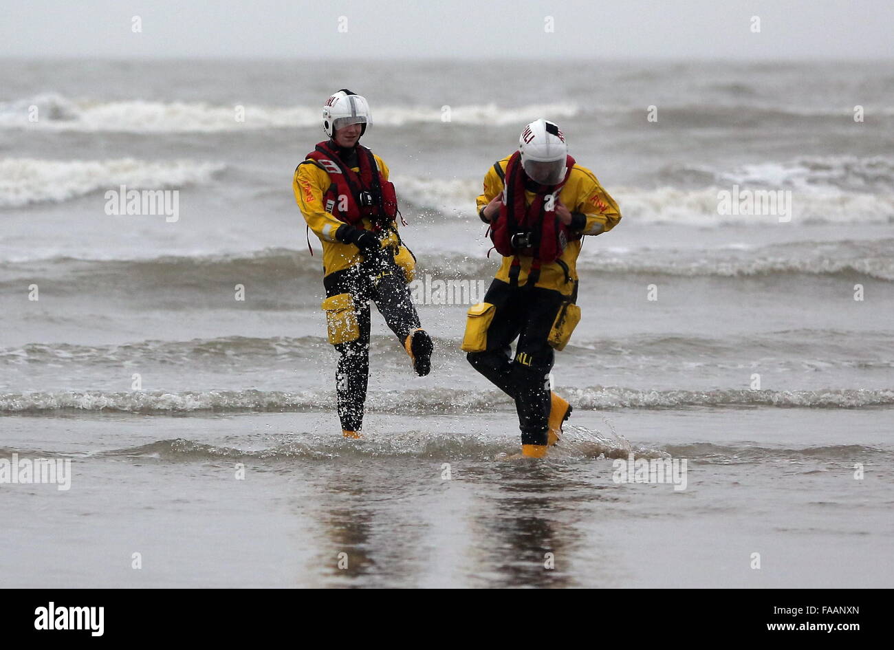 Porthcawl, UK. Friday 25 December 2015  RNLI crew members splashing each other in the seaRe: Hundreds of people in fancy dress, have taken part in this year's Christmas Swim in Porthcawl, south Wales. Credit:  D Legakis/Alamy Live News Stock Photo