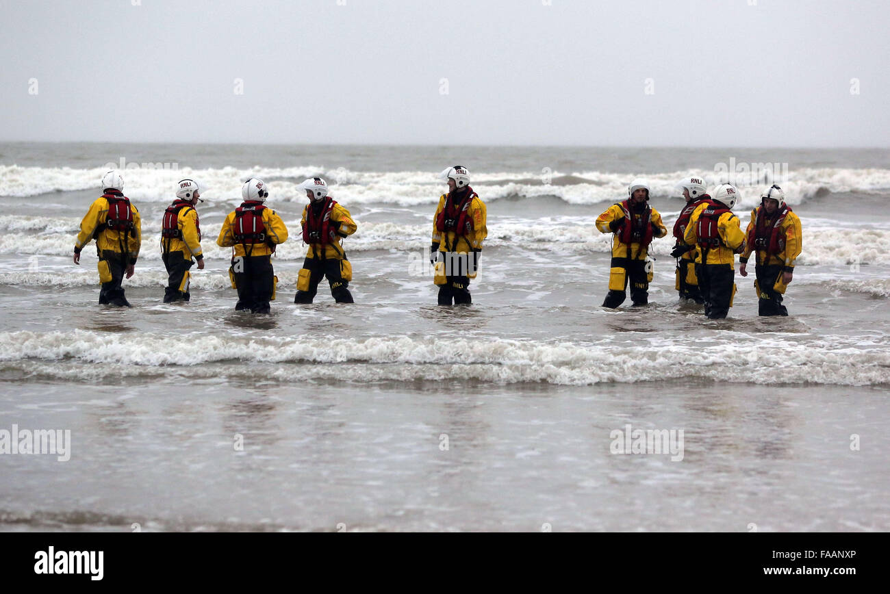 Porthcawl, UK. Friday 25 December 2015 RNLI crew members in the seaRe: Hundreds of people in fancy dress, have taken part in this year's Christmas Swim in Porthcawl, south Wales. Credit:  D Legakis/Alamy Live News Stock Photo