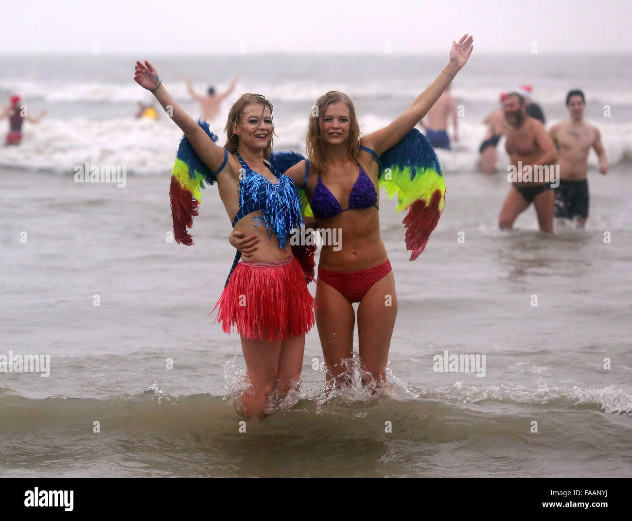 Porthcawl, UK. Friday 25 December 2015 Two young ladies in angel wingsRe: Hundreds of people in fancy dress, have taken part in this year's Christmas Swim in Porthcawl, south Wales. Credit:  D Legakis/Alamy Live News Stock Photo