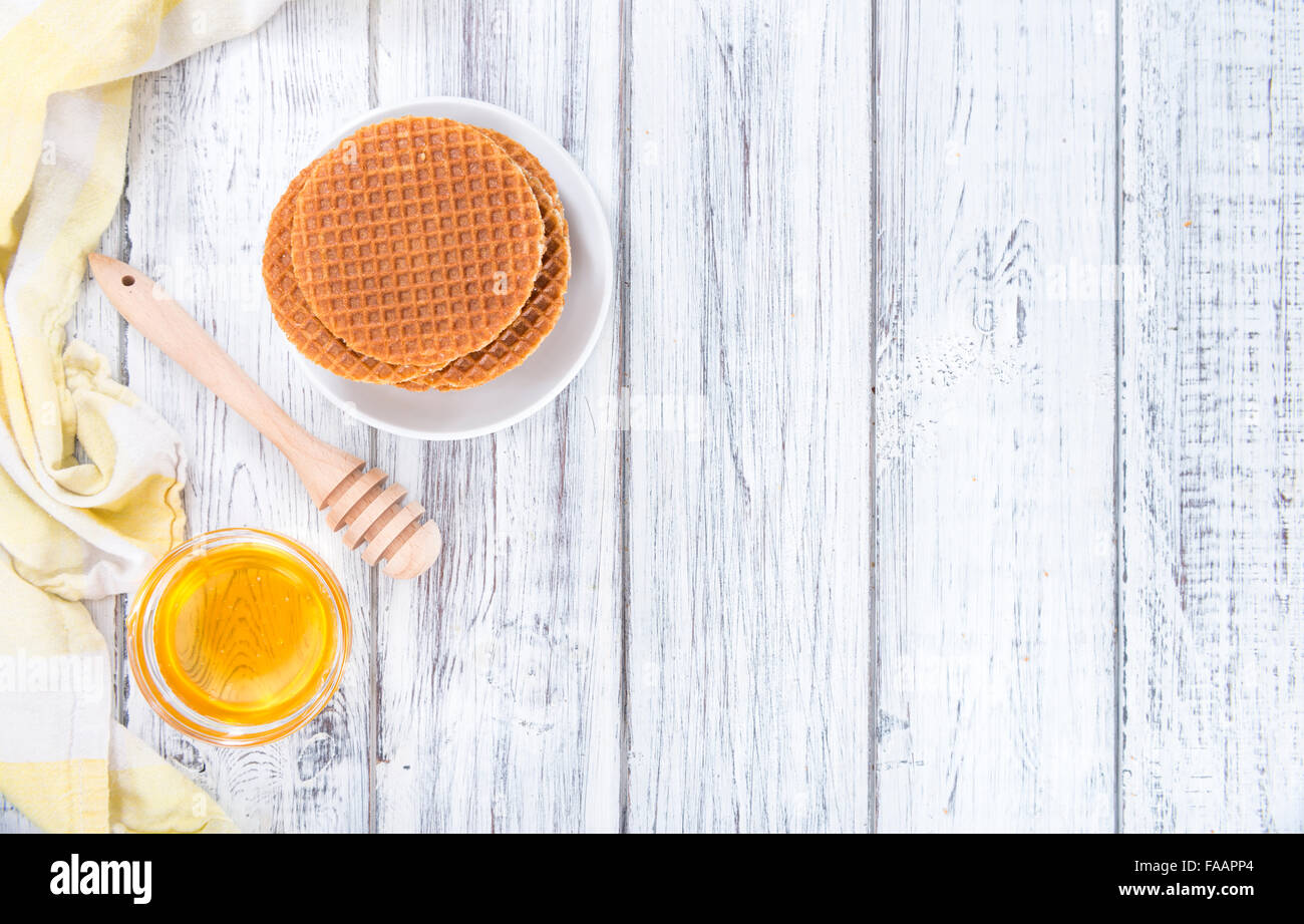 Crunchy homemade Waffles filled with golden honey (on wooden background) Stock Photo