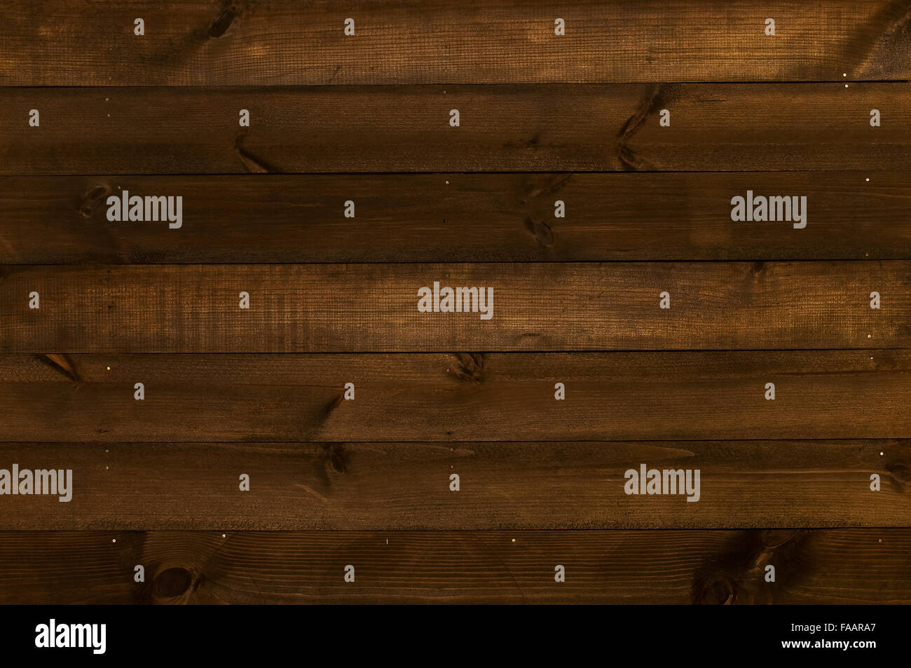 Wooden wall made of poorly processed dark old planks arranged horizontally Stock Photo