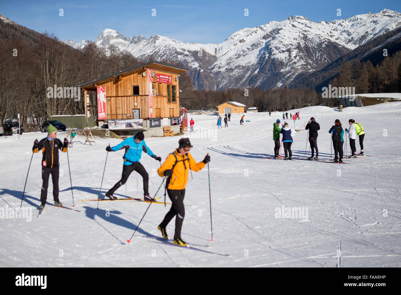 Ulrichen, Switzerland. 25th December, 2015. Crosscountry skier in front of the Nordic Centre. There is a lack of snow in the skiing areas of Switzerland. Slopes are created with artificial snow to attract some tourists and reduce the economical loss.  Credit:  Dominic Steinmann/Alamy Live News Stock Photo