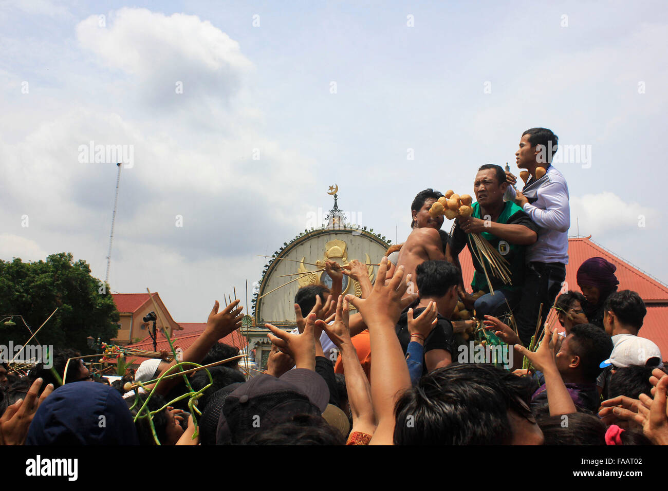 Residents scramble the contents of gunungan while Grebeg Maulud of