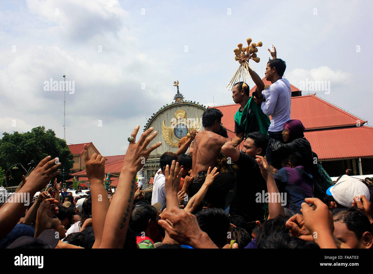 Residents scramble the contents of gunungan while Grebeg Maulud of