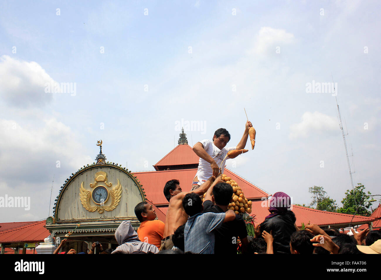 Residents scramble the contents of gunungan while Grebeg Maulud of