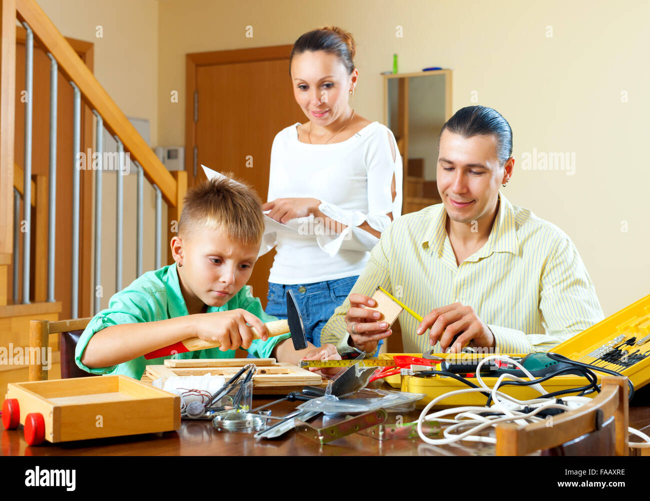 Nice family together doing something with working tools at home Stock Photo