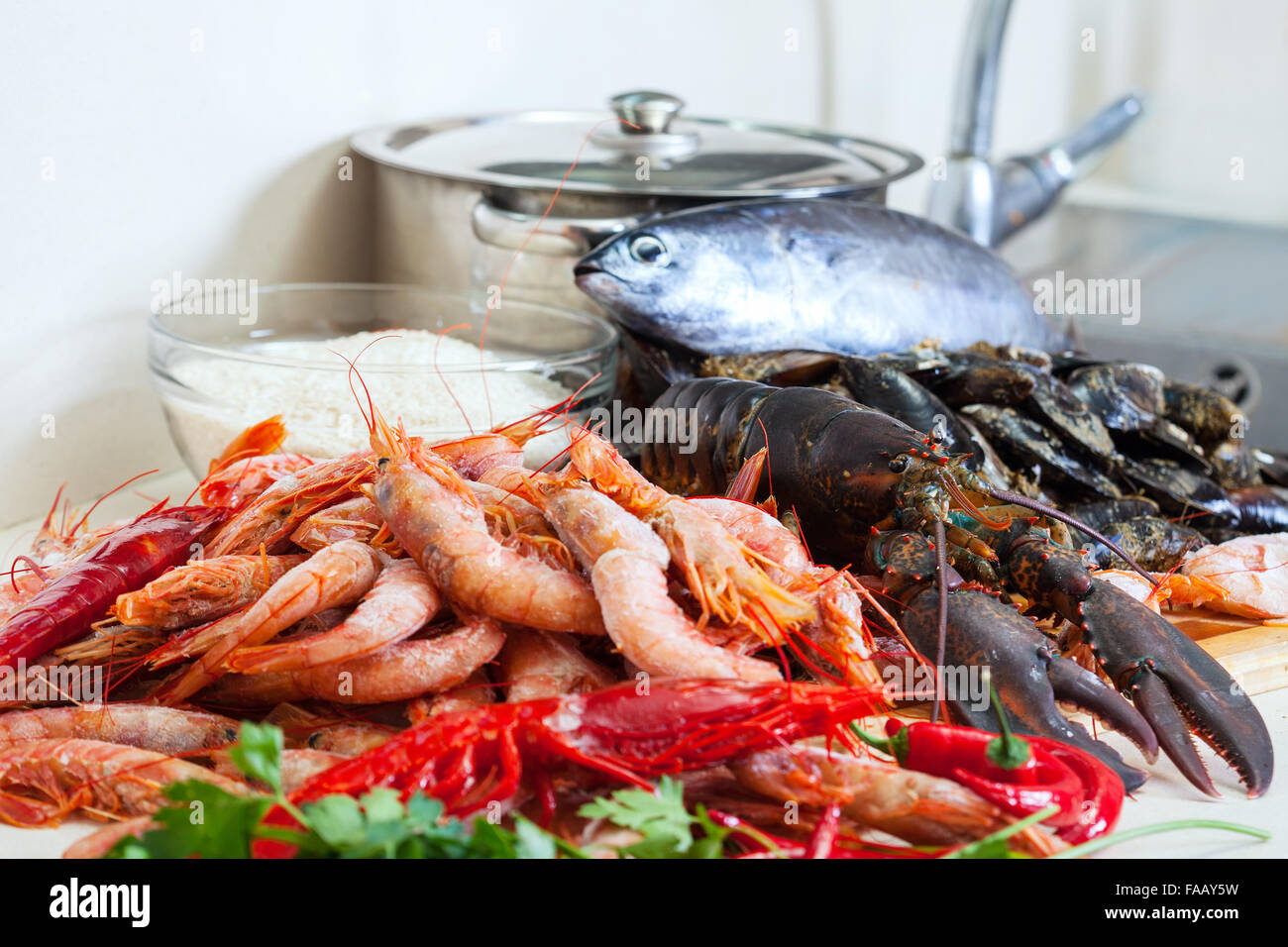 Fresh raw sea foods and fish at cooking table Stock Photo - Alamy