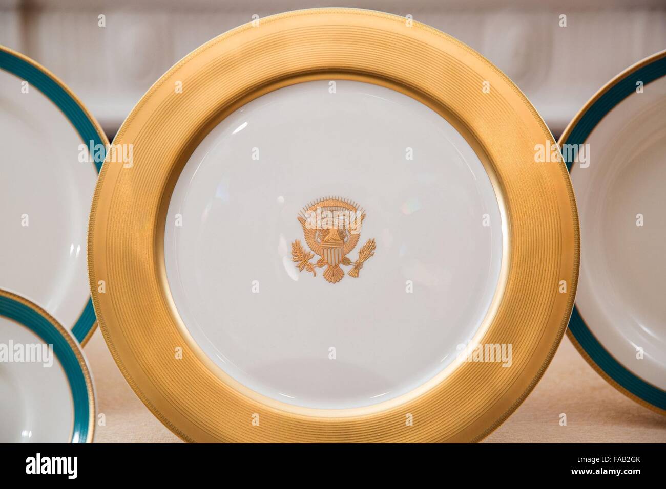 Gold banded dinner plate from the new Obama China service in the China Room of the White House April 23, 2015 in Washington, DC. The eleven-piece setting for 320 was manufactured in the Obamas home state of Illinois by Pickard China of Antioch. Stock Photo