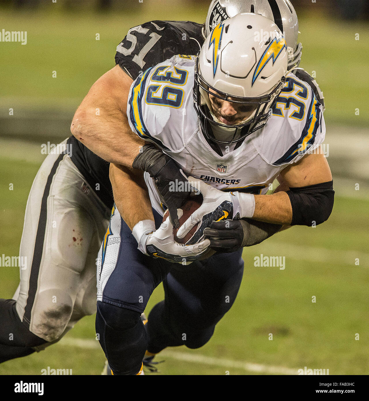 Oakland, California, USA. 24th Dec, 2015. Oakland Raiders inside linebacker Ben Heeney (51) tackles San Diego Chargers running back Danny Woodhead (39) on Sunday, December 24, 2015, at O.co Coliseum in Oakland, California. The Raiders defeated the Chargers 23-20. Al Golub/CSM/Alamy Live News Stock Photo